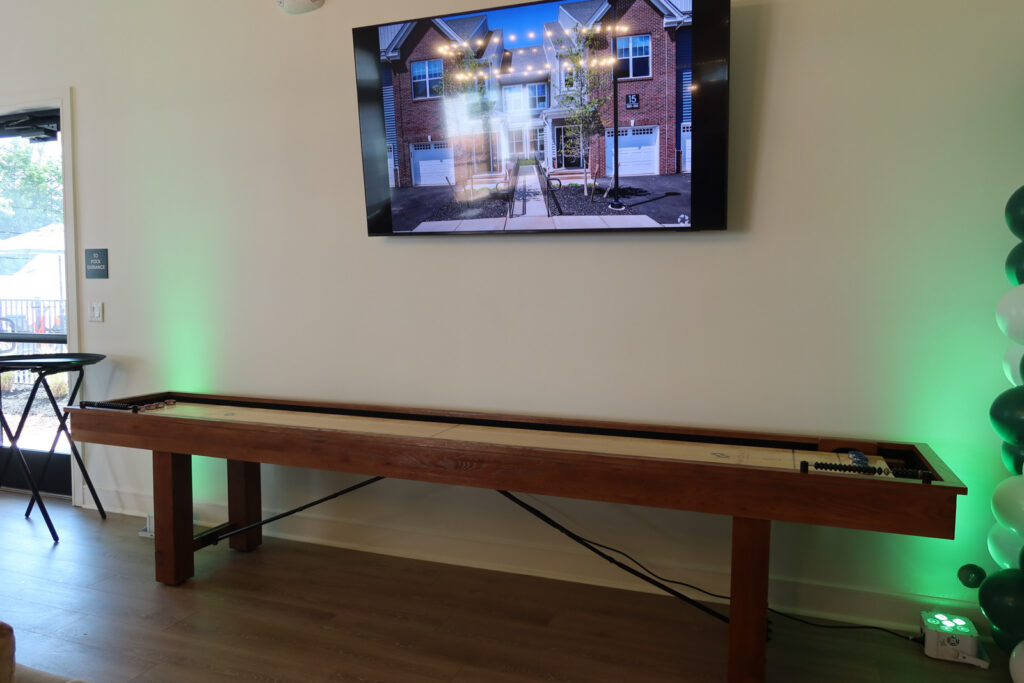 shuffleboard and television in apartment complex clubhouse