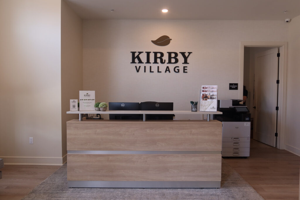 office desk with Kirby Village logo on wall in clubhouse of apartment complex in somerville New Jersey