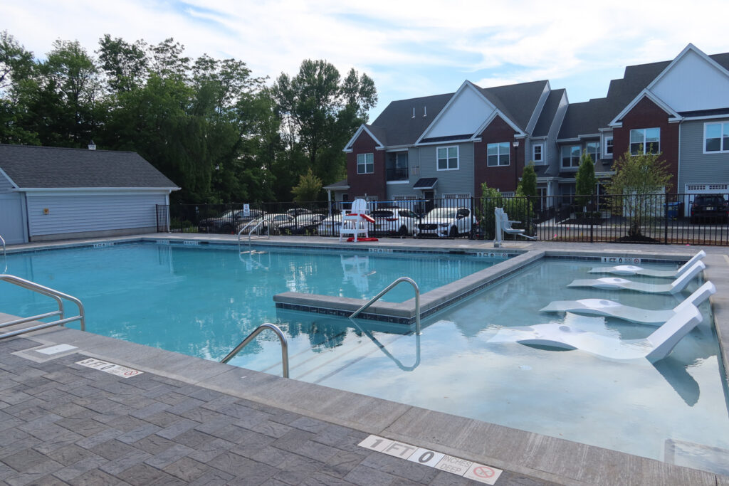 exterior pool with lounge chairs on beautiful summer day in Somerville New Jersey apartments