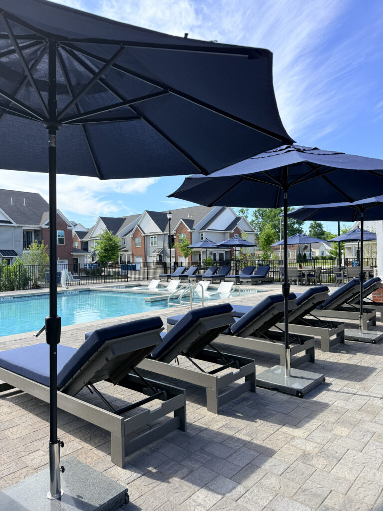 exterior pool with lounge chairs on beautiful summer day in Somerville New Jersey apartments