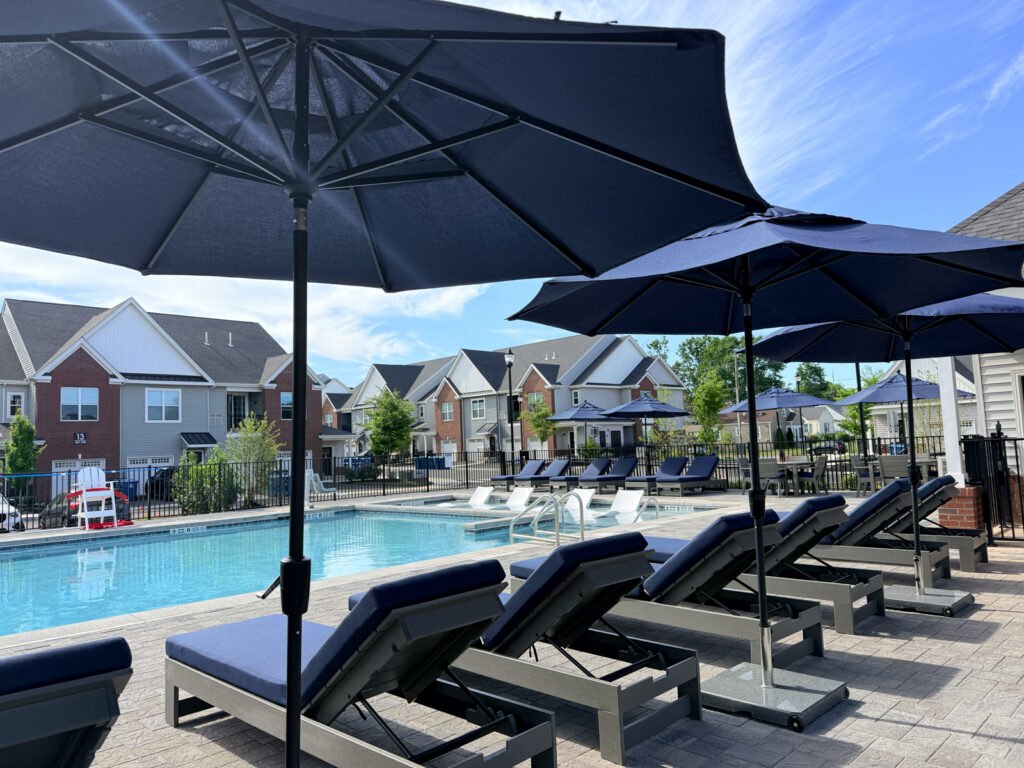 exterior pool with lounge chairs on beautiful summer day in Somerville New Jersey apartments